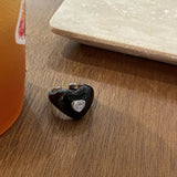 Qfdian  A cute, heart-shaped ring with a pearlescent white finish and a zircon setting on the index finger