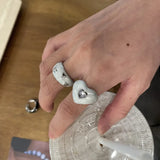 Qfdian  A cute, heart-shaped ring with a pearlescent white finish and a zircon setting on the index finger
