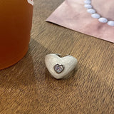 Qfdian  A cute, heart-shaped ring with a pearlescent white finish and a zircon setting on the index finger